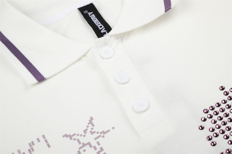 Close-up of rhinestone horse graphic and front buttons on white polo shirt