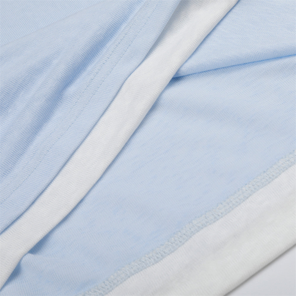 Close-up of light blue and white fabric layers with stitched seams