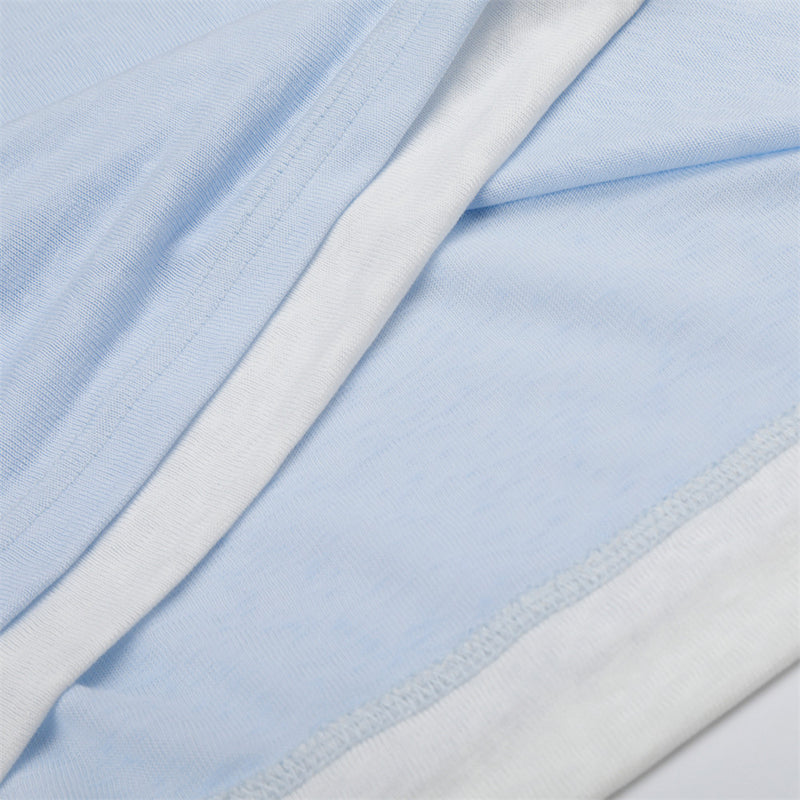 Close-up of light blue and white fabric layers with stitched seams