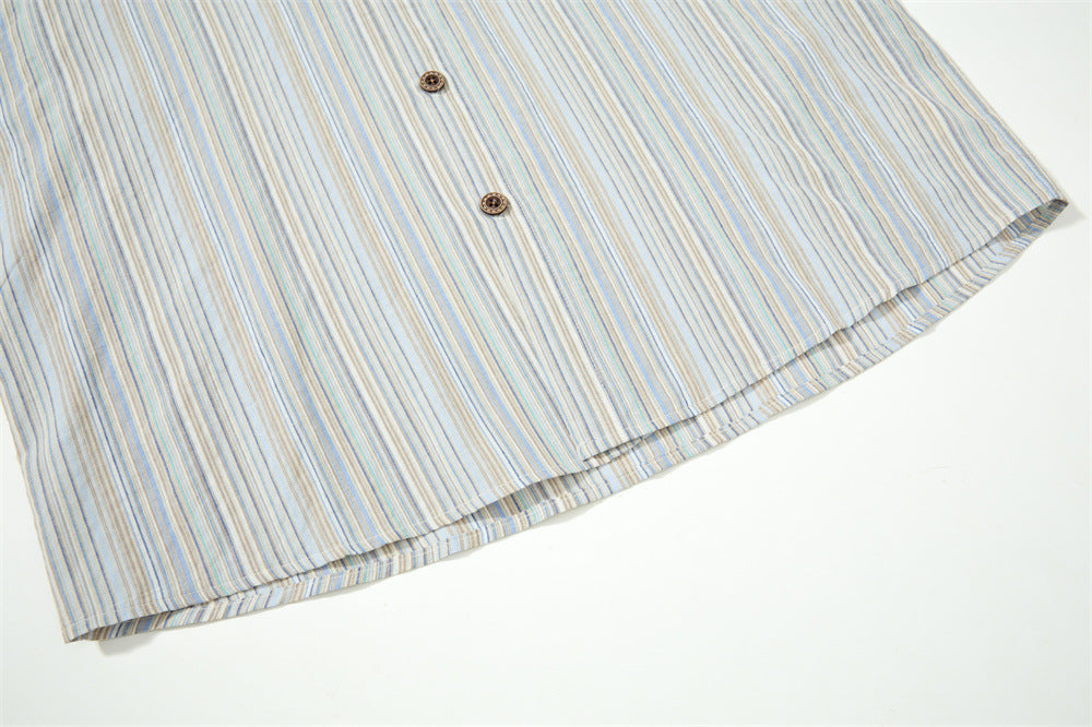 Close-up of striped shirt hem with two buttons