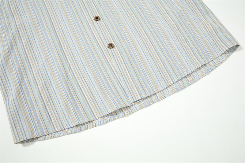 Close-up of striped shirt hem with two buttons