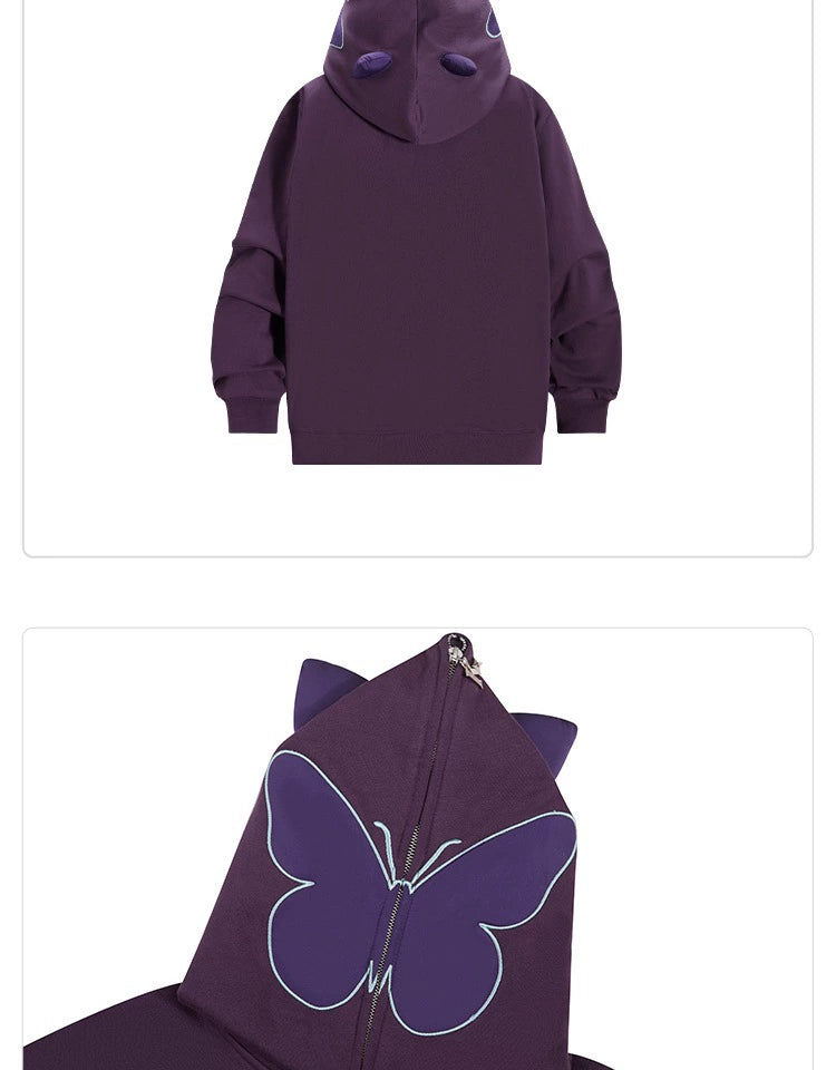 The Seakoff Butterfly Hoodie is a 400GSM oversized zip-up sweatshirt in purple and mint green, featuring ear-like accents and a nature-inspired light blue butterfly outline on the hood, perfect for any trendsetter.