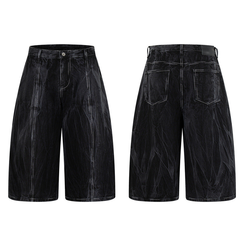Crinkle-washed black wide-leg denim shorts with contrast white topstitching, front and back view