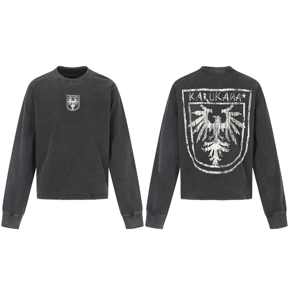 Karukama eagle crest washed black long-sleeve tee showing distressed full-back shield graphic and small chest crest