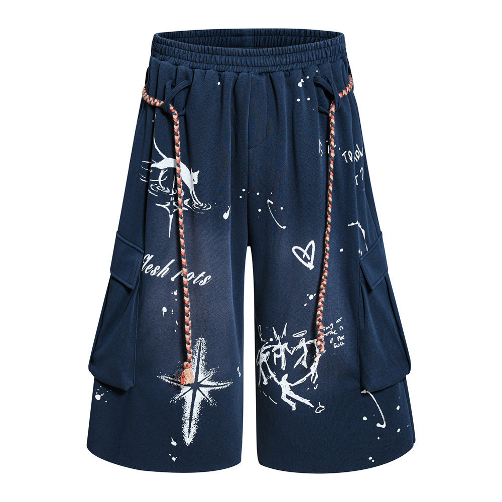 Men's wide-leg graffiti cargo shorts in navy with hand-drawn print, braided rope drawstring, and cargo pockets