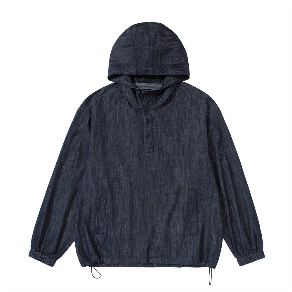 Men's oversized indigo denim pullover anorak hoodie with half-button placket, structured hood, and drawstring hem — front and