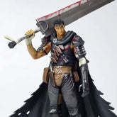 The Berserk Guts Brand Marked Bloodstained Version Action Figure features a warrior with spiky hair wielding a large bloodstained sword. Dressed in dark armor with various straps and a tattered cape, he stands defiantly against a plain white background.