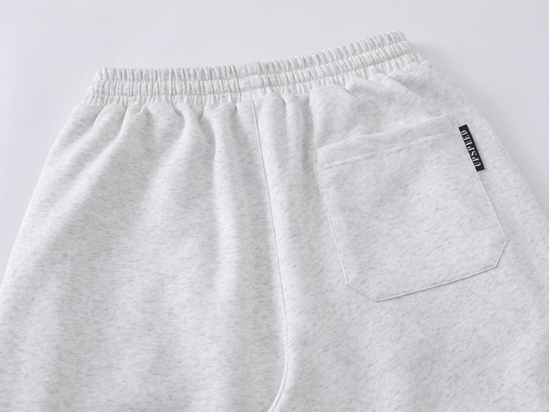 Pantalon de survêtement à jambes larges avec passepoil contrastant et écusson brodé