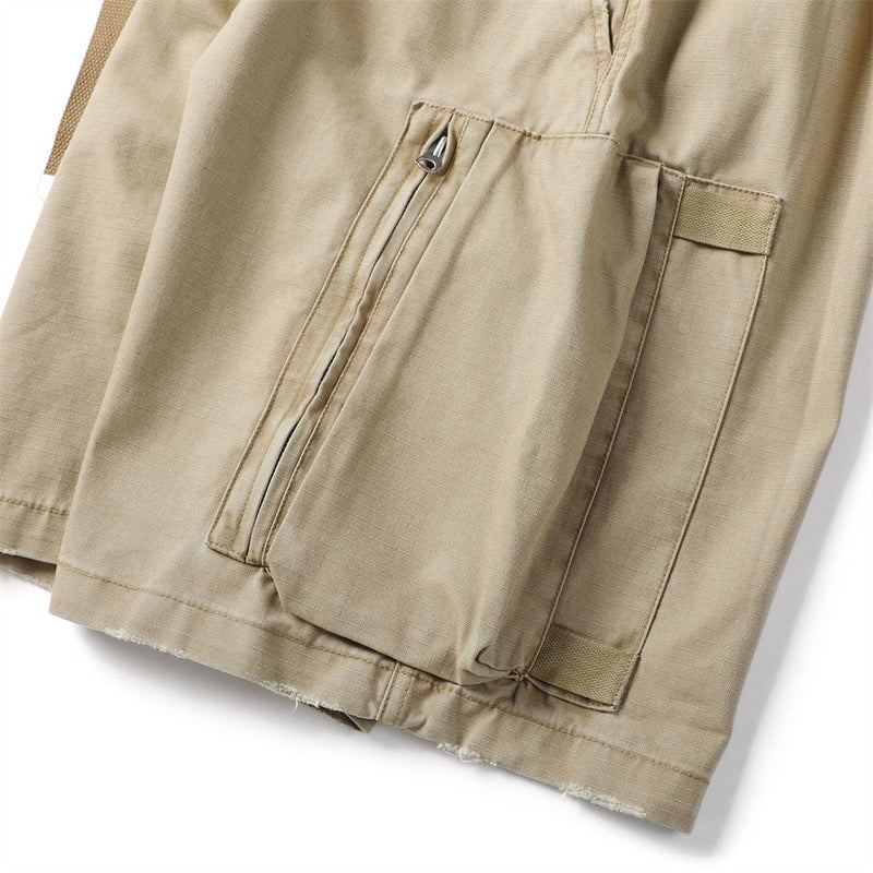 Close-up of khaki cargo shorts side pocket with zip opening and cargo flap pocket