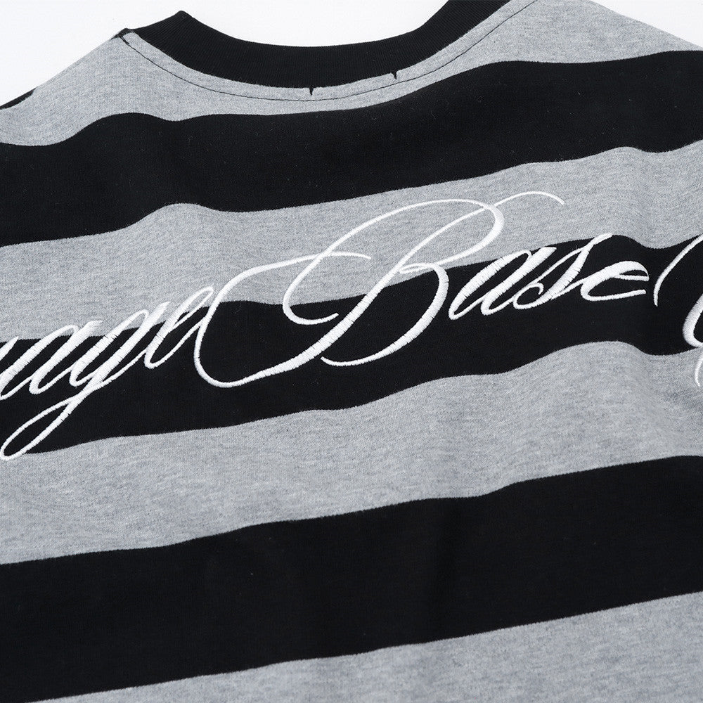 Close-up of back graphic lettering on black and gray striped long sleeve shirt