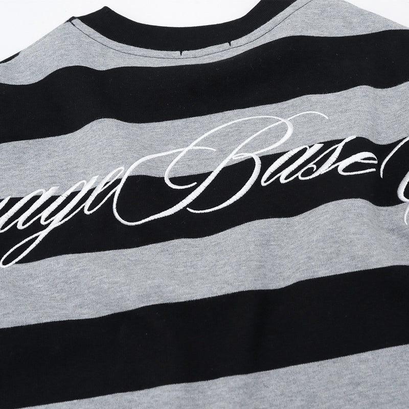 Close-up of back graphic lettering on black and gray striped long sleeve shirt