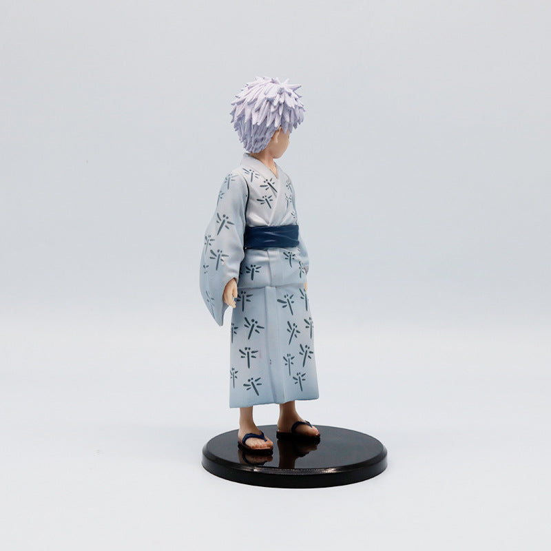 The Jujutsu Kaisen Satoru Gojo PVC Figure is an 18 cm collectible statue featuring the anime character in a light blue traditional yukata with a dark patterned sash, spiky white hair, and set on a black circular base.