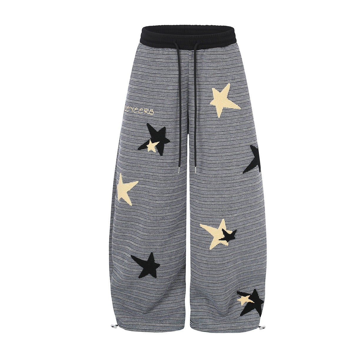 Wide-leg dark grey striped sweatpants with cream and black star appliqués, ribbed black waistband and drawstring