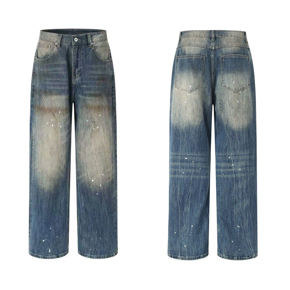 Men's vintage distressed wide-leg baggy jeans in nostalgic blue with amber mud-wash fading and white paint splatter detailing
