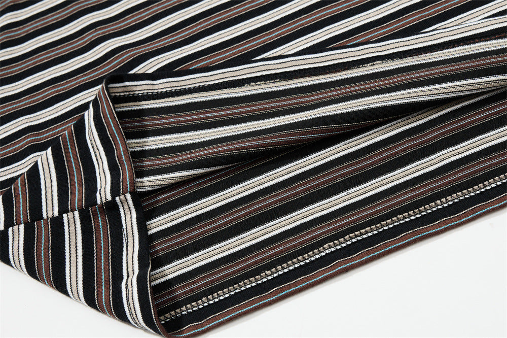 Close-up of striped sleeve seam and cuff stitching on black Henley shirt