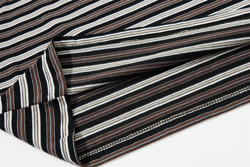 Close-up of striped sleeve seam and cuff stitching on black Henley shirt