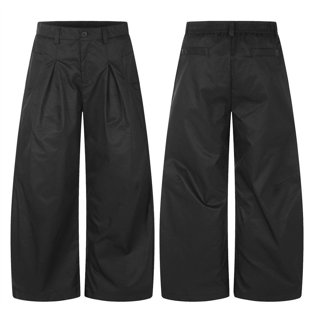 Black oversized wide-leg pleated trousers with curved hem, front and back view