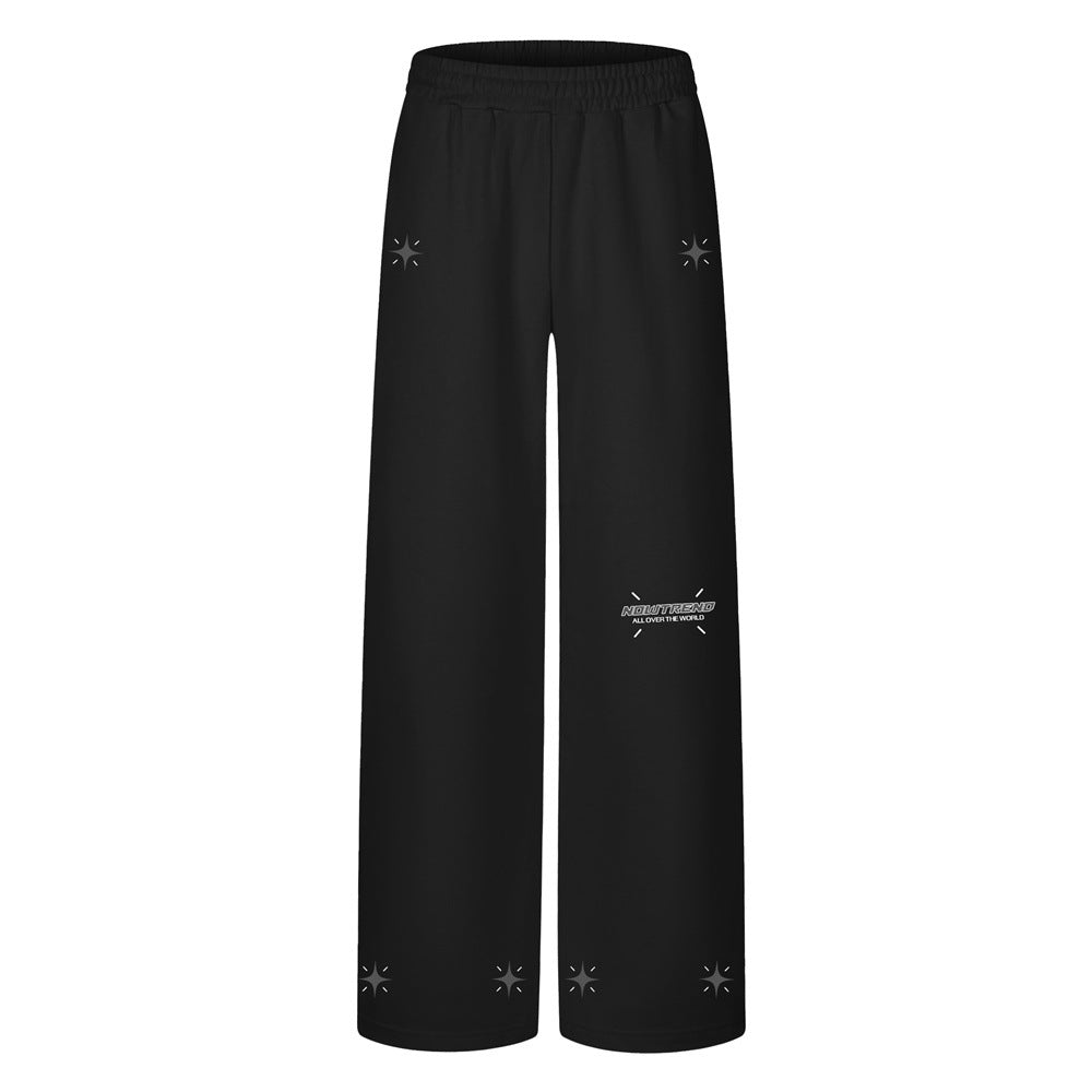 Men's wide-leg sweatpants with star graphic print and logo detail in black, front view