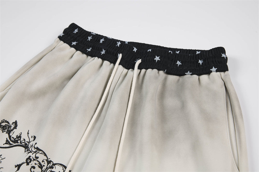Pantalon de survêtement à jambes larges motif baroque – Imprimé usé, ceinture à étoiles