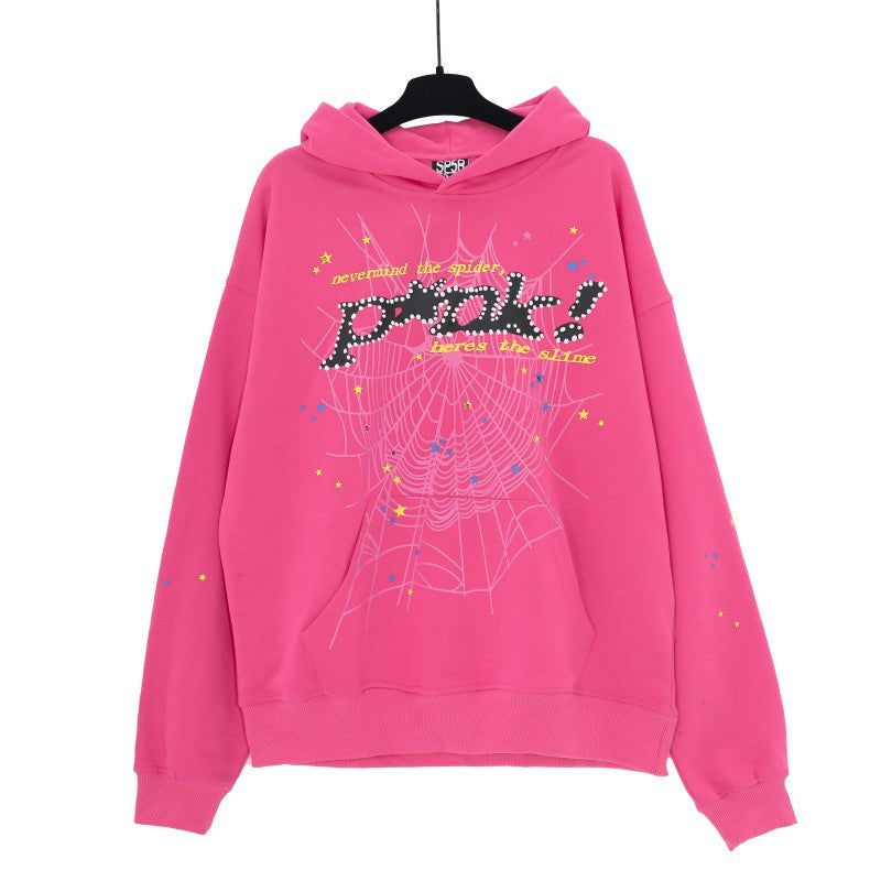 The Vibrant Pink Sp5der Hoodie is a Trendy Web Print Sweatshirt featuring a playful spider web with &quot;Peek!&quot; design and colorful text and stars. This eye-catching Sp5der streetwear piece is displayed on a black hanger against a white backdrop.