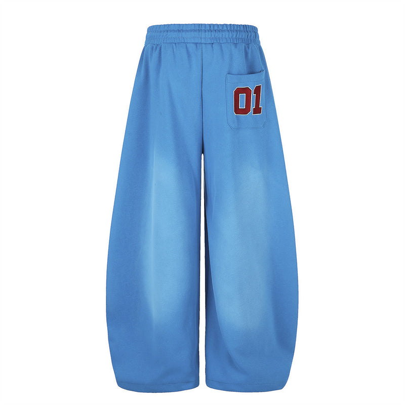 Blue wide-leg sweatpants back view with 01 patch on the right pocket