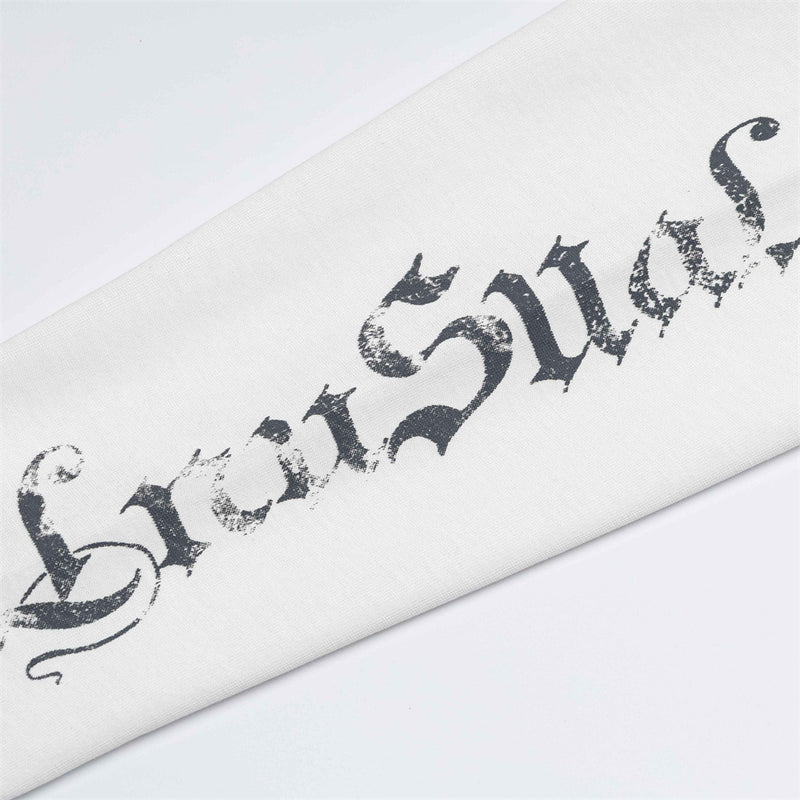 Close-up of distressed gothic text printed on a white sleeve