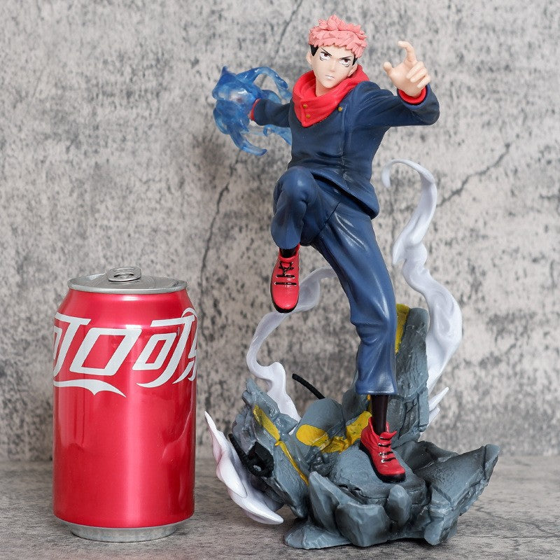 The Jujutsu Kaisen Yuji Itadori PVC Figure is a 24 cm collectible statue featuring the character in an action pose with cursed energy effects, dressed in a blue outfit, red shoes, and hood. Poised on a rocky base with white wisps, it stands next to a red soda can.