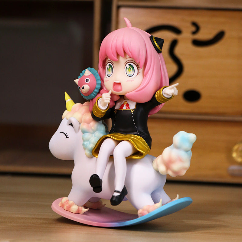 The Spy x Family Anya Forger 15 cm PVC figure features Anya with vivid pink hair on a rocking unicorn toy, a round creature on her shoulder, and interchangeable face expressions.