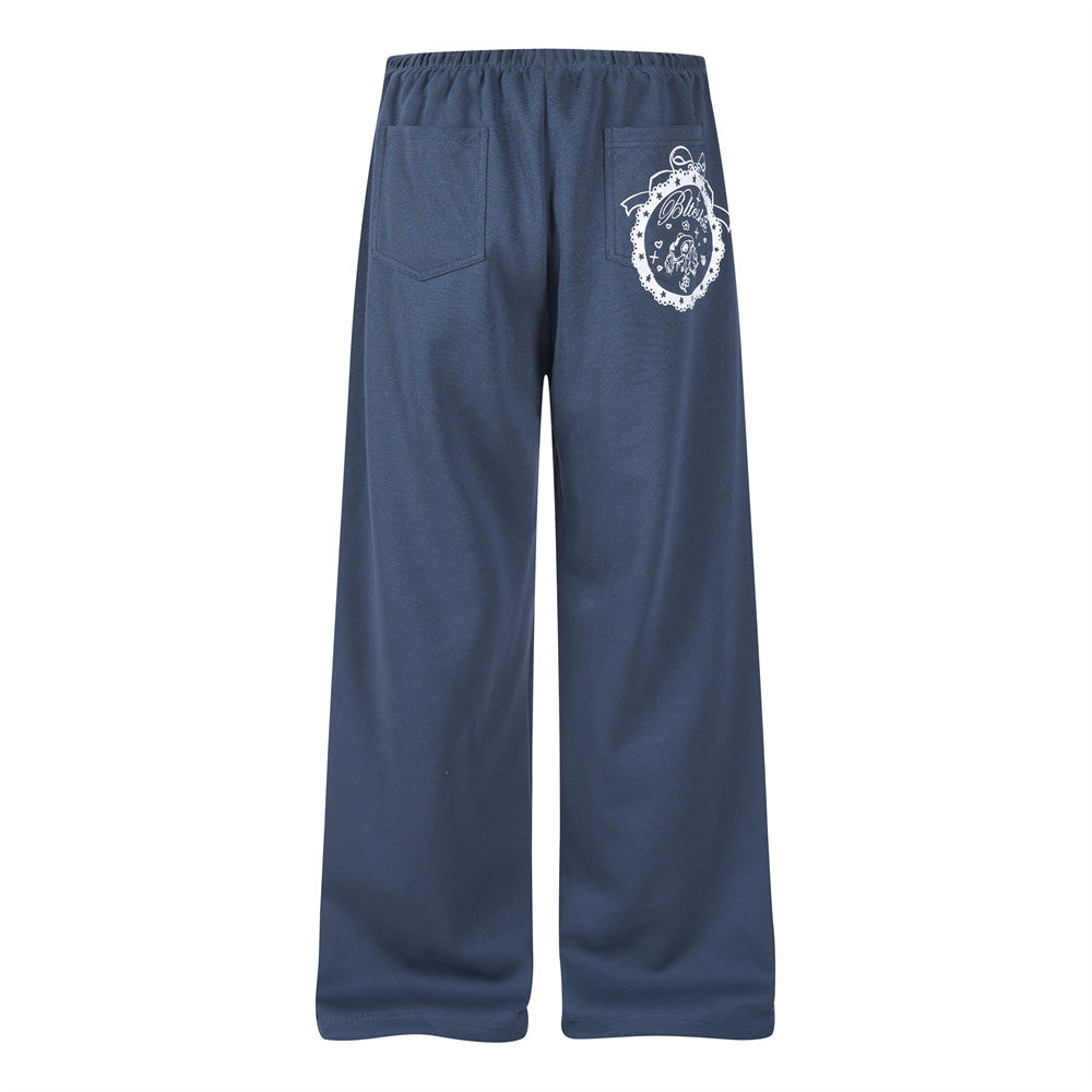 Back view of navy wide-leg track pants with back pockets and white printed graphic