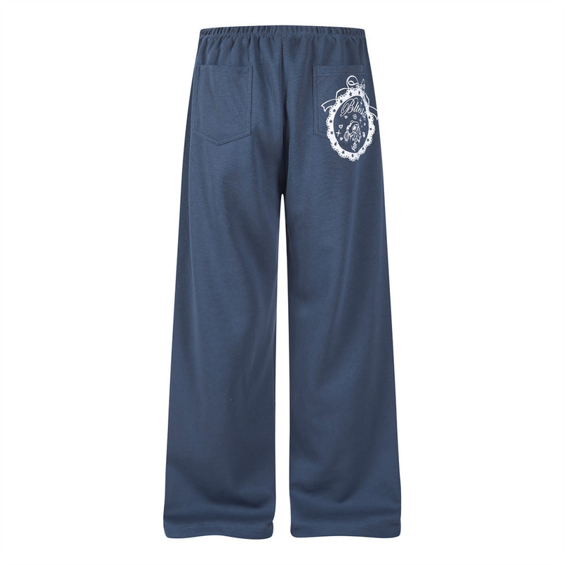 Back view of navy wide-leg track pants with back pockets and white printed graphic