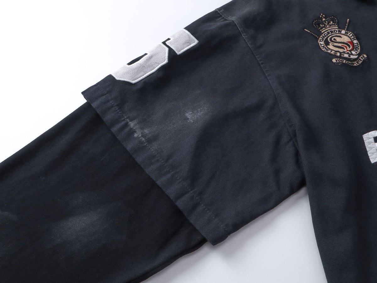Polo de rugby oversize con lavado ácido – Mangas de falsa capa y bordado de gran tamaño