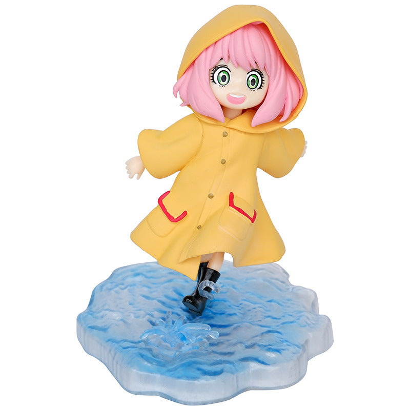 Introducing the Anya Forger Yellow Raincoat Figure - Cute PVC Anime Collectible from Spy × Family. This figure features a pink-haired character with bright green eyes, joyfully splashing in a textured puddle base, her yellow raincoat with red pockets capturing her playful expression mid-step.