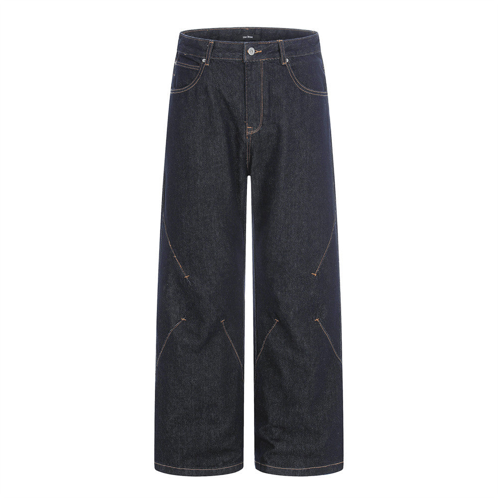 Men's wide-leg raw indigo denim jeans with diagonal orange contrast seam detailing, front and back view