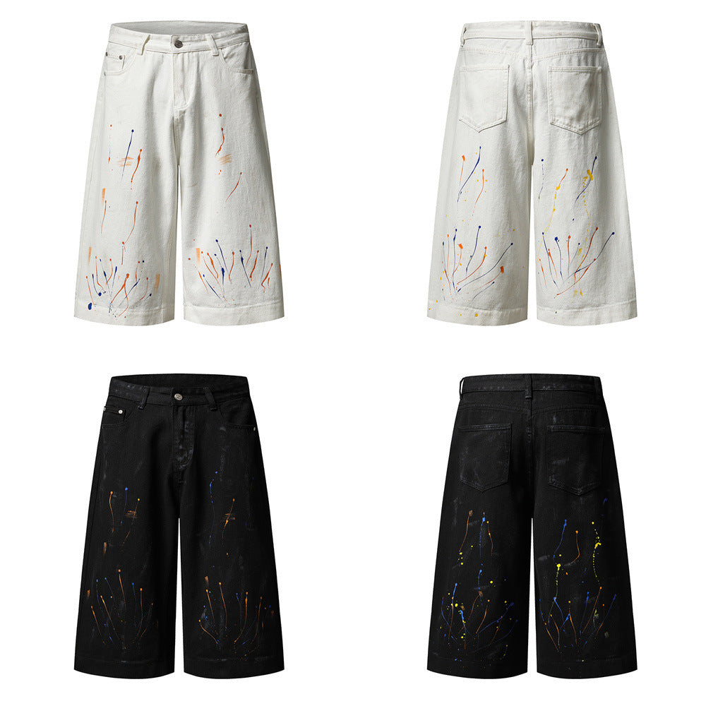 Men's wide-leg denim shorts with multicolor paint splatter drip print in black and white colorways