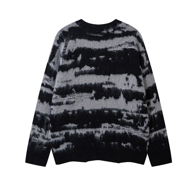 Back view of a black and gray distressed stripe jacquard knit sweater with ribbed cuffs and hem