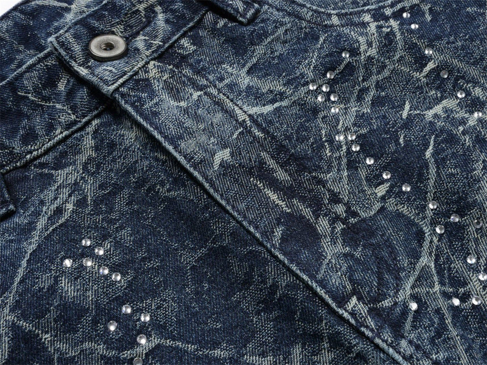 Close-up of denim front panel with rhinestone constellation print and faded wash