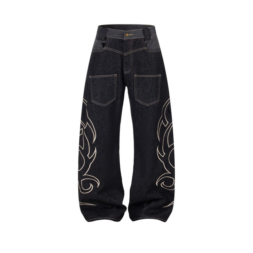Full front view of black wide-leg denim jeans with tribal flame embroidery