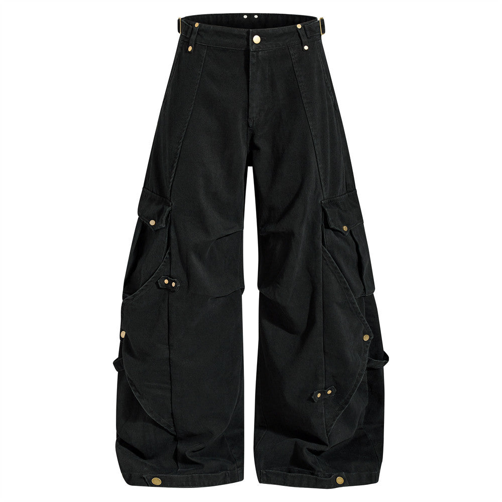 Wide-leg deconstructed cargo pants with multi-pocket design and gold hardware in washed black