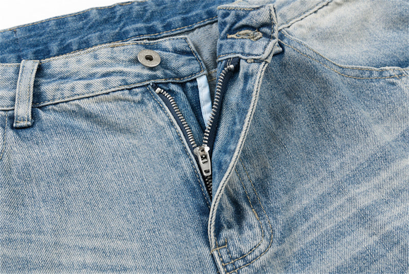 Close-up of front fly and button on light blue distressed denim shorts