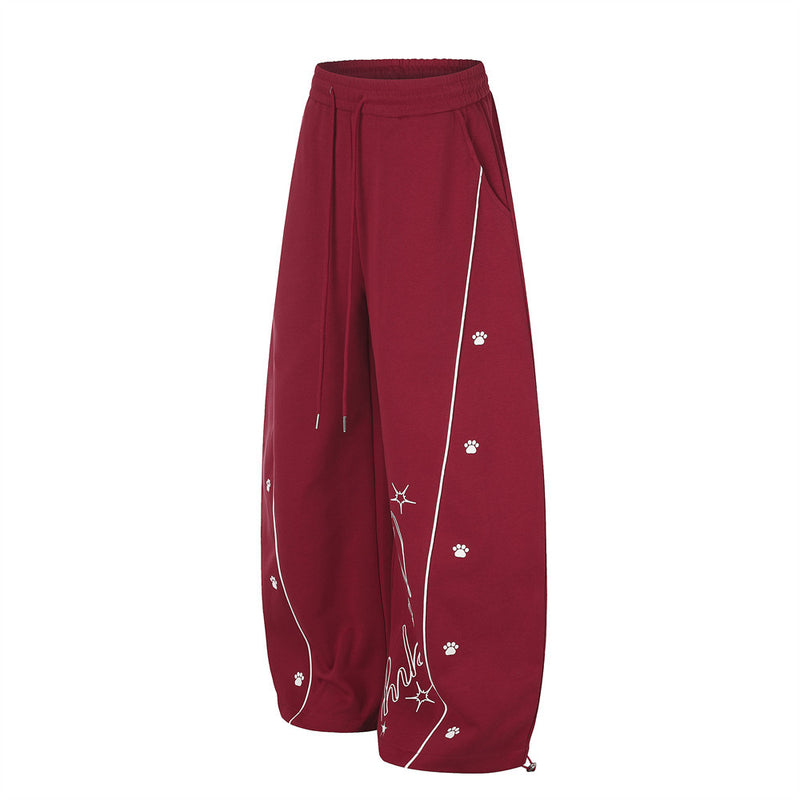 Pantalon de jogging large – Motif patte et coutures courbes rouges