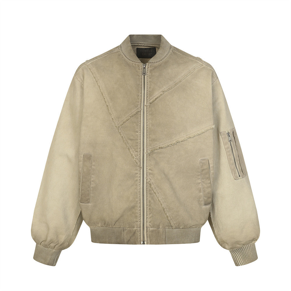 Blouson bomber oversize déconstruit en toile délavée, assemblage patchwork et coutures à bords francs, présenté en gris et kaki