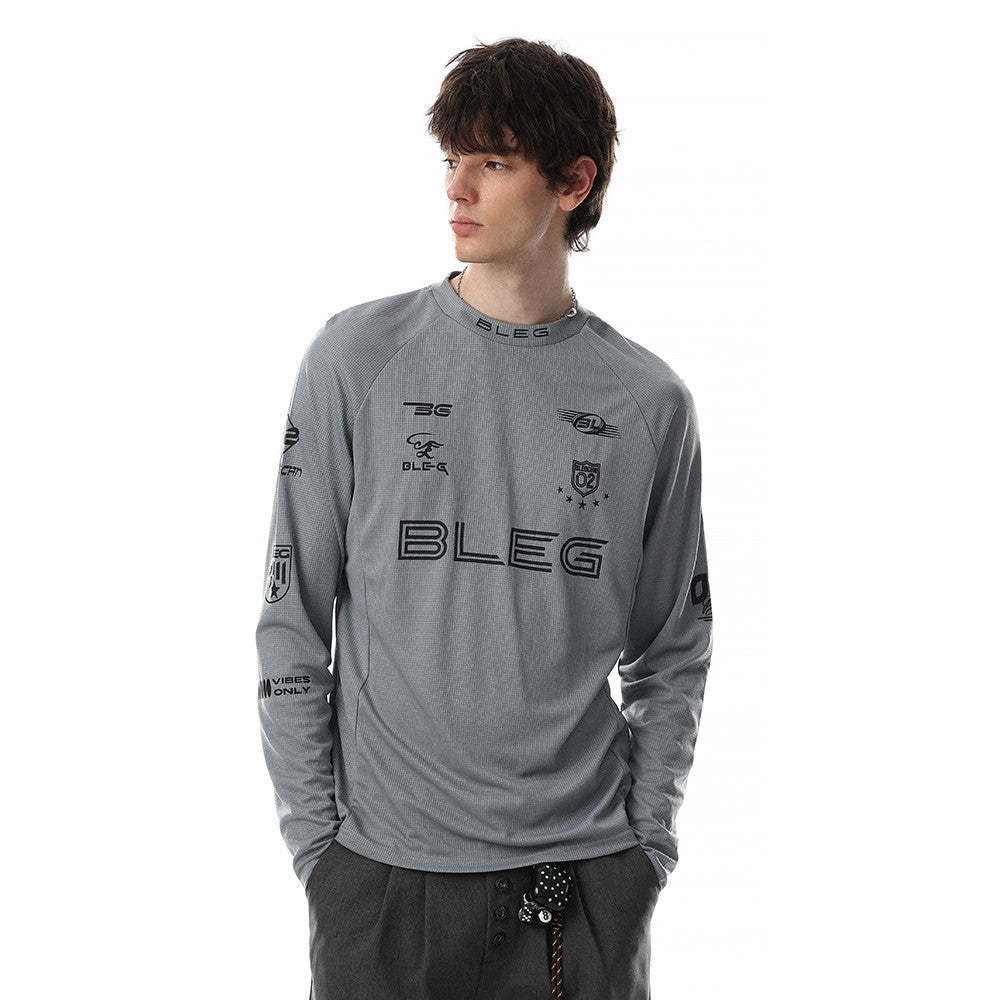 Gray long sleeve crew neck shirt worn by model with black multi-logo racing graphics