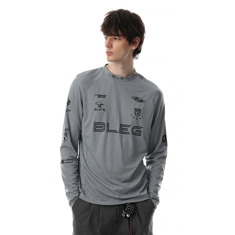 Gray long sleeve crew neck shirt worn by model with black multi-logo racing graphics