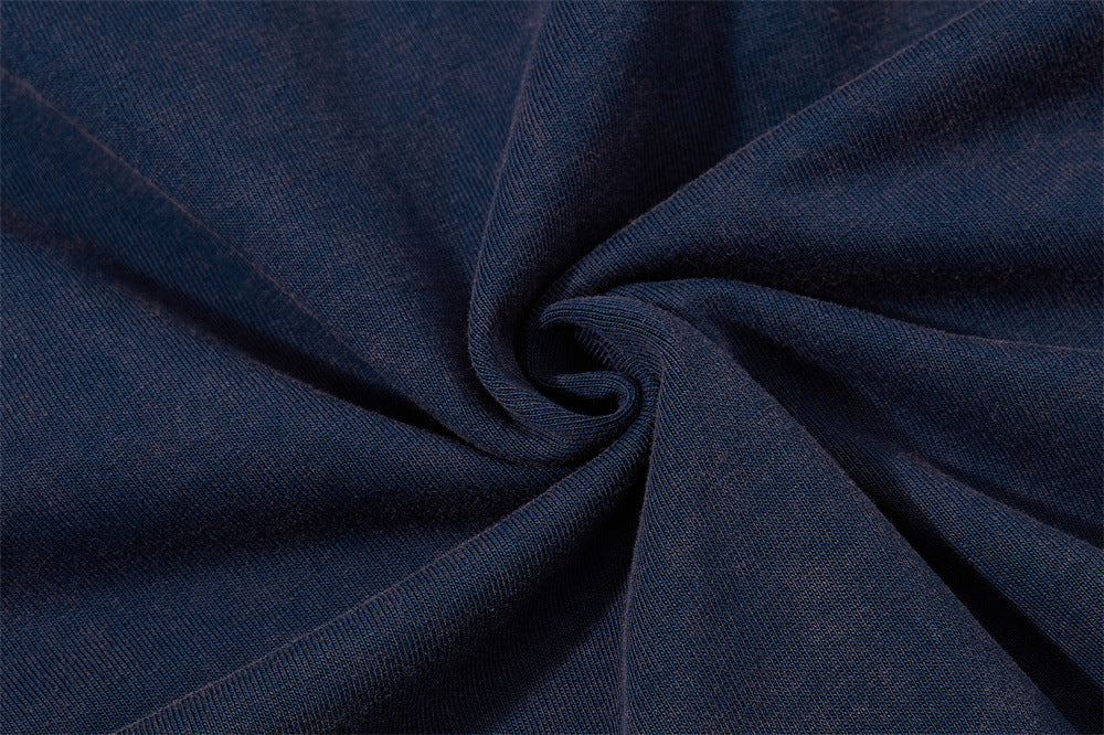 Close-up of navy blue knit fabric with a spiral texture from the vintage star patch raglan colorblock T-shirt