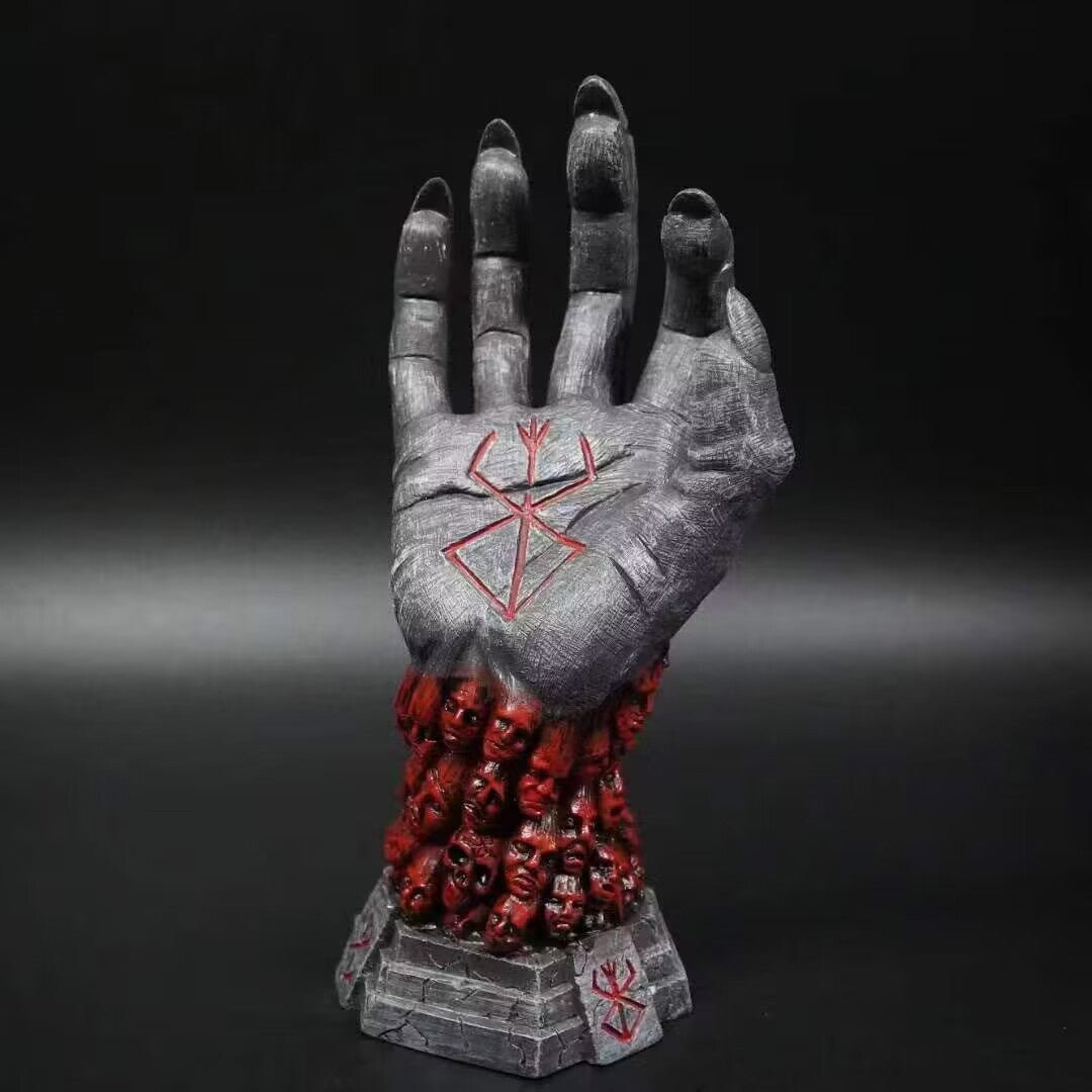 The Berserk Furious God Hand Statue, a 24 cm PVC display by Berserk, features a gray hand with a red emblem and rises from small red skulls, its eerie details enhanced by the dark background to capture the haunting essence of an anime figure.