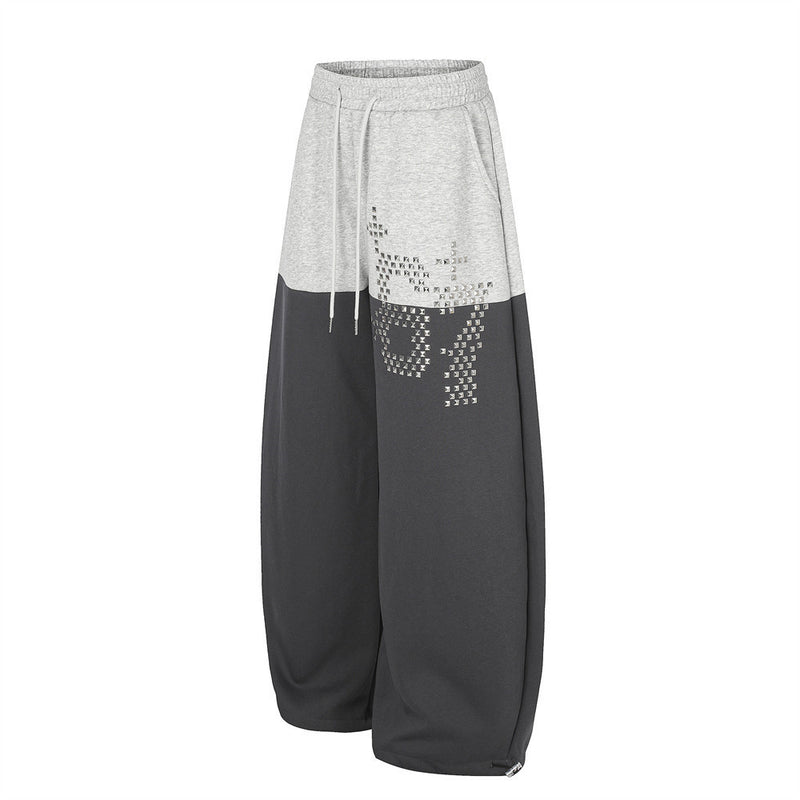 Pantalones de Chándal de Pierna Ancha con Bloques de Color y Detalles Gráficos de Tachuelas Plateadas