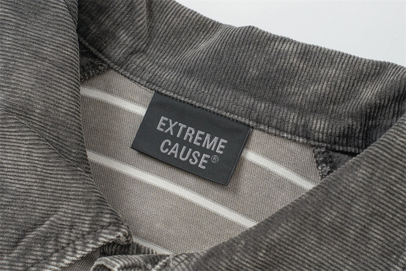 ヴィンテージウォッシュ加工のストライプ柄カラーブロックポロシャツのクローズアップ。リブ編みの襟とExtreme Causeラベル付き