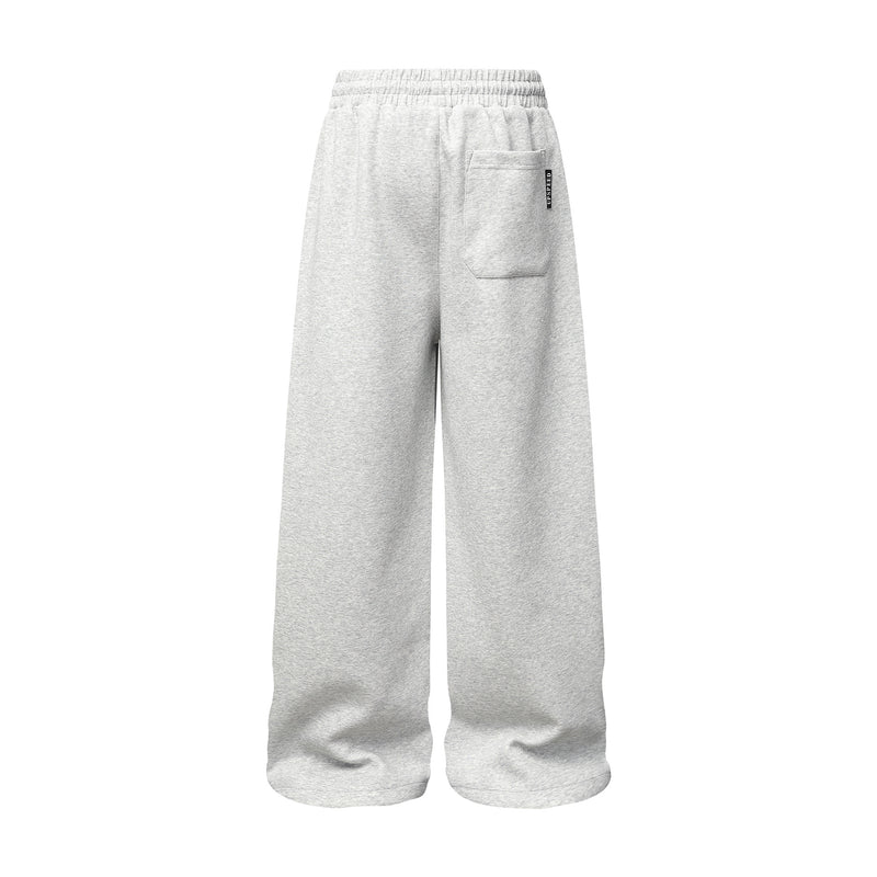 Pantalon de survêtement à jambes larges avec graphisme graffiti et ourlet orné de détails métalliques