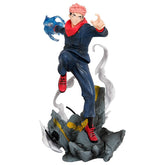 The Jujutsu Kaisen Yuji Itadori PVC Figure, a 24 cm collectible statue, showcases a dynamic action pose. Featuring pink hair, a dark blue outfit, red shoes, and standing on a rocky base with swirling effects while holding blue cursed energy, it&