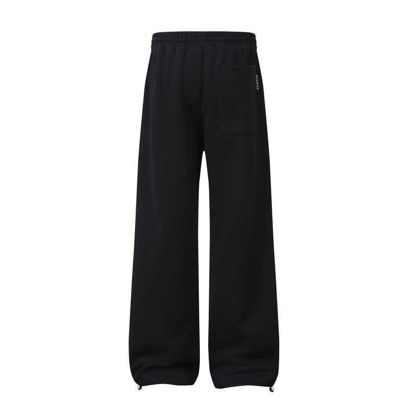 Pantalon de survêtement à jambes larges avec graphisme héraldique et détails latéraux multibandes